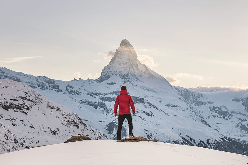 person in red hoodie standing on snowy mountain during daytime, HD wallpaper