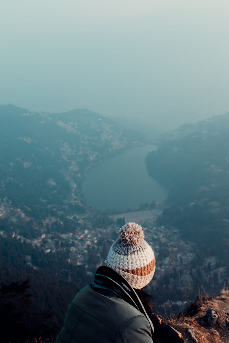 person in black jacket and brown and white plaid hat standing on top of the mountain, HD phone wallpaper
