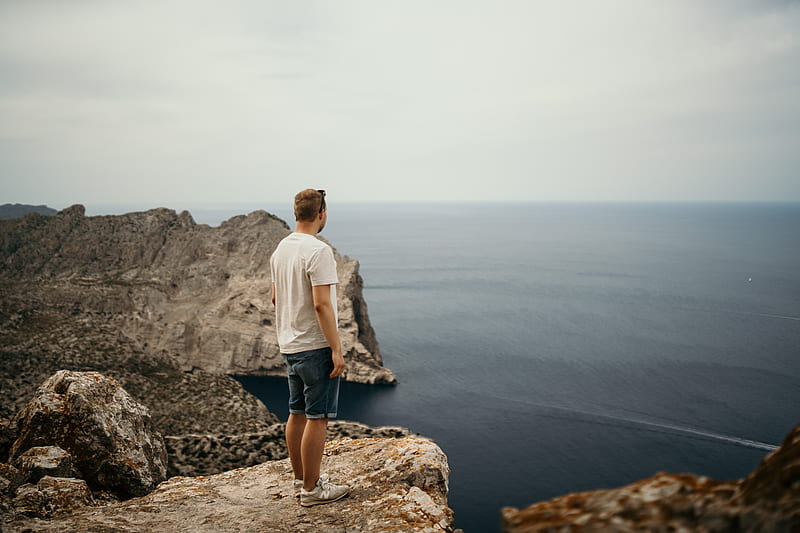 Man standing on mountain range near body of water, HD wallpaper | Peakpx