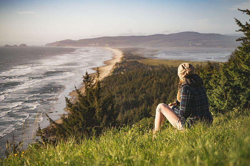 person sitting on hill near ocean during daytime, HD wallpaper