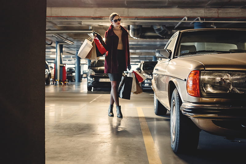 woman carrying shopping paper bags walking towards beige car inside parking lot, HD wallpaper
