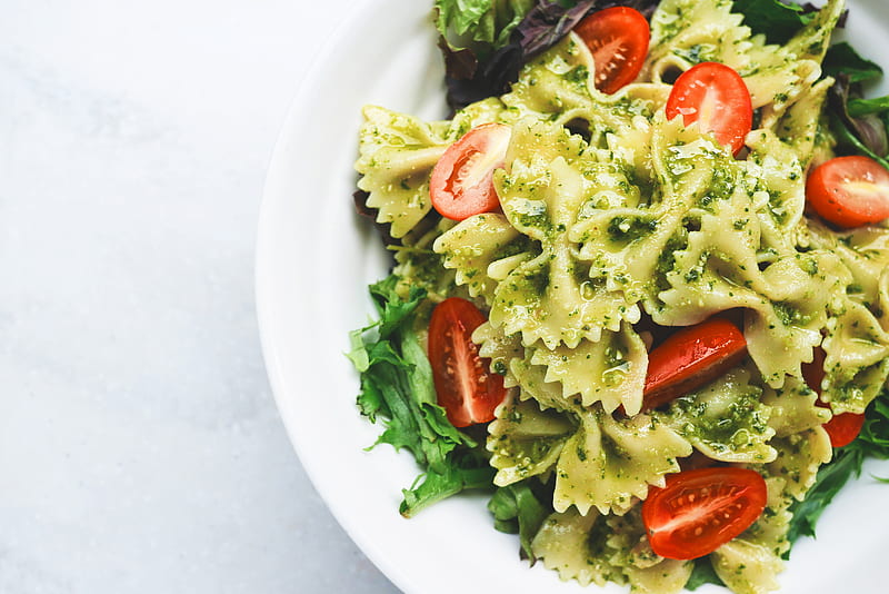 Pesto pasta with sliced tomatoes served on white ceramic plate, HD wallpaper
