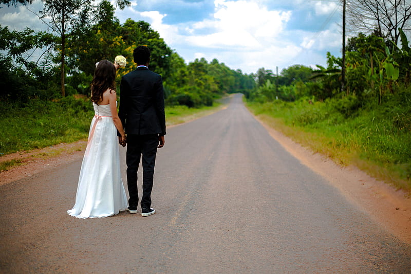 wedding couple standing on winding road between trees under cumulus cloud, HD wallpaper
