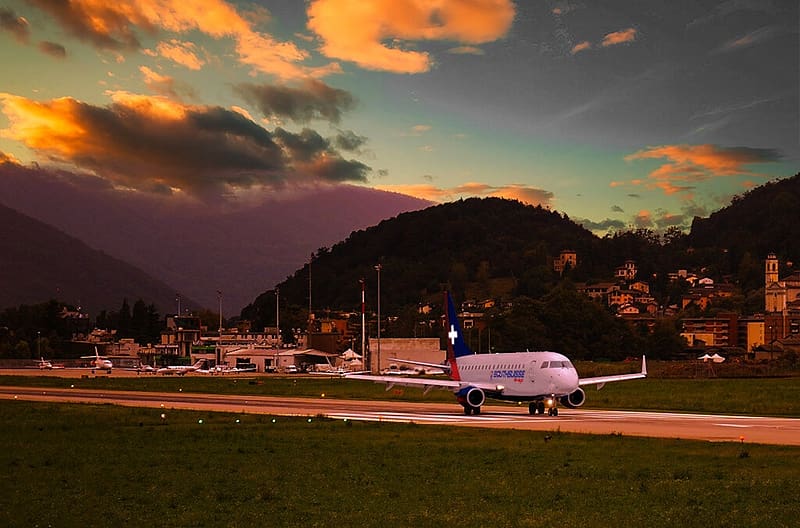 LUGANO REGIONAL AIRPORT CH, SMALL JET, HILLS, RUNWAY, AIRPORT BUILDINGS, CRAZY CLOUDS, HD wallpaper