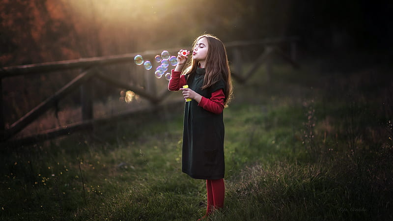 Cute Little Girl Is Blowing Bubbles Wearing Red Black Dress In Fence With Sunbeam Background Cute, HD wallpaper