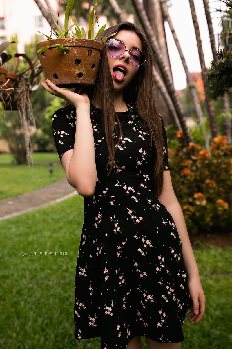 Alice Sudos , women, model, brunette, portrait, outdoors, garden, grass, plants, flowers, depth of field, dress, sunglasses, women with shades, looking at viewer, long hair, open mouth, tongues, tongue out, women outdoors, HD phone wallpaper