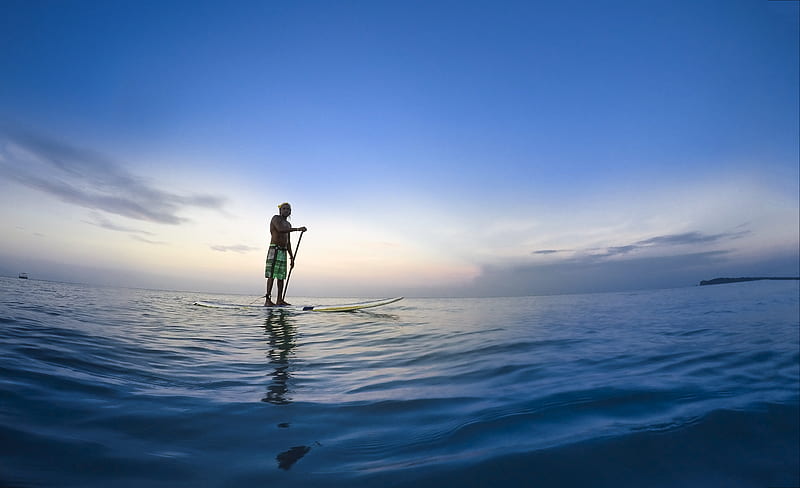 man standing on white paddle board holding paddle on body of water under blue sky, HD wallpaper
