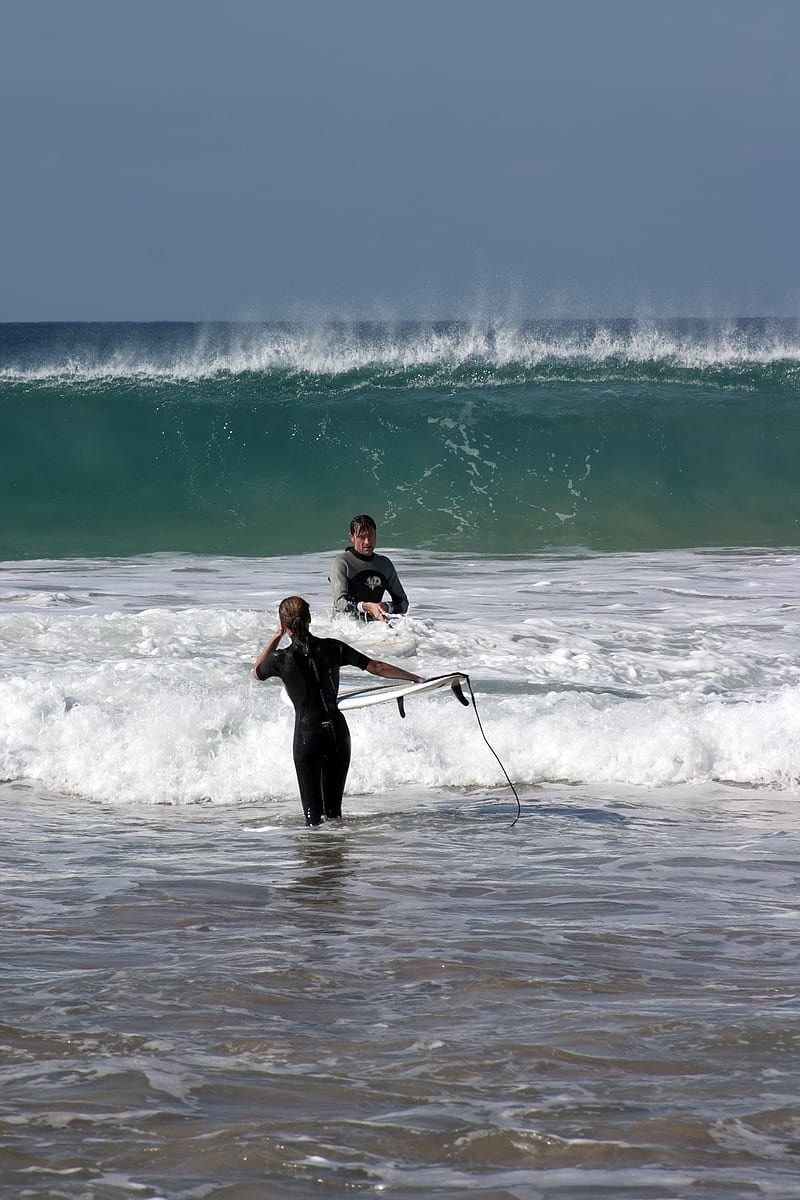 man in black wet suit holding white surfboard on beach during daytime, HD phone wallpaper