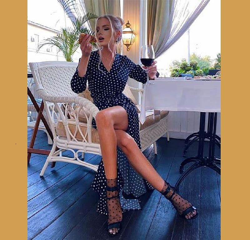 Alena Vragevskaya, croissant, blonde, navy blue dress, sitting, glass of wine, heels, table, window, white polka dots, plant, HD wallpaper