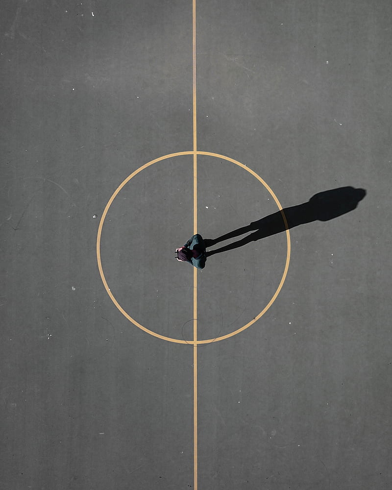 man stainding on black concrete floor casting shadow, HD phone wallpaper