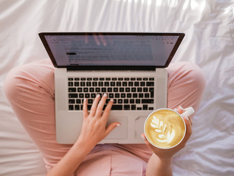 person using MacBook Pro and holding cappuccino, HD wallpaper