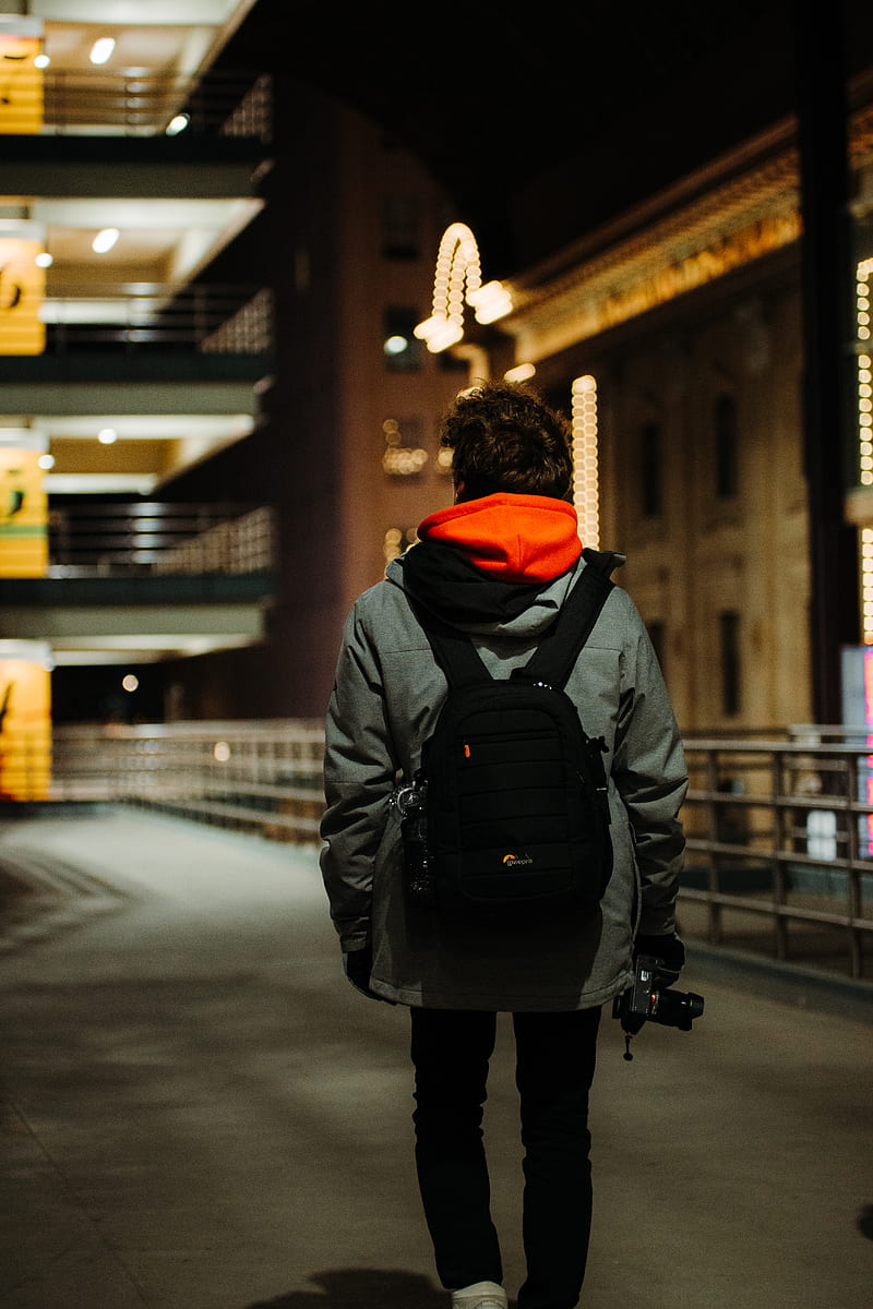 person in black jacket and orange knit cap walking on sidewalk during night time, HD phone wallpaper