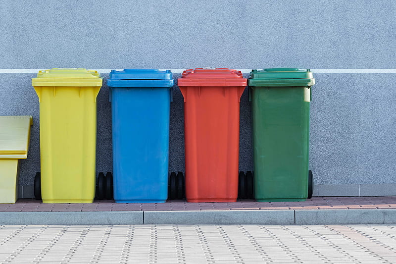 four assorted-color trash bins beside gray wall, HD wallpaper