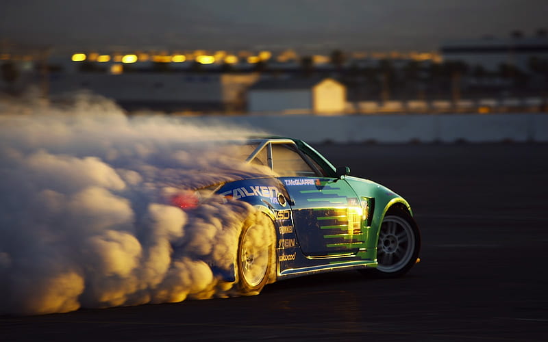 drift car drifting around a tire stack 4k night time