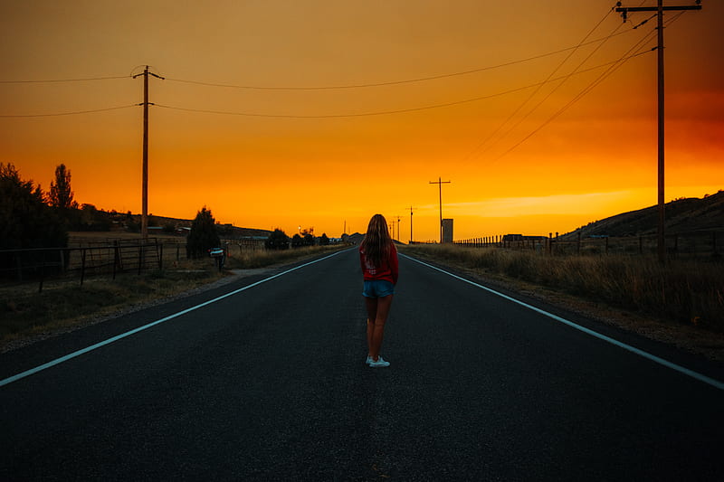 woman in blue t-shirt and blue denim shorts standing on road during sunset, HD wallpaper