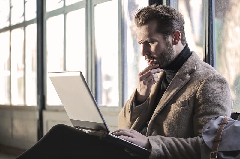 man holding his chin facing laptop computer, HD wallpaper