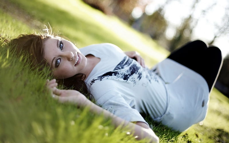 Erotic woman lying in grass wallpapers