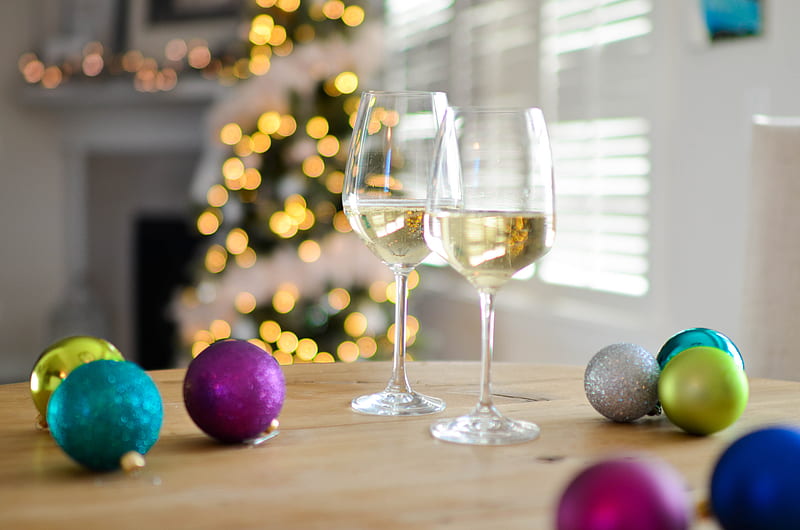 two clear footed wineglasses filled with yellow liquid near assorted-color ball ornaments, HD wallpaper