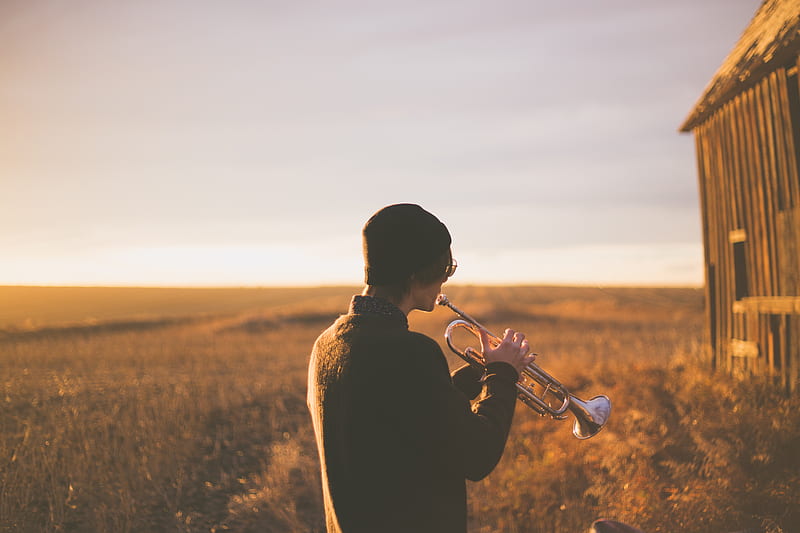 man playing trumpet outside house on field during daytime, HD wallpaper