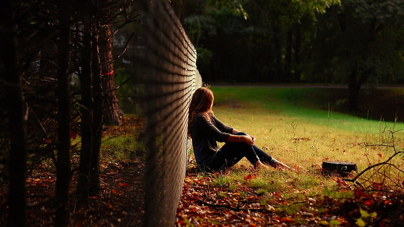 Sad Looking Girl Is Sitting On Green Grass Leaning Back On Chain Link Fence Sad, HD wallpaper