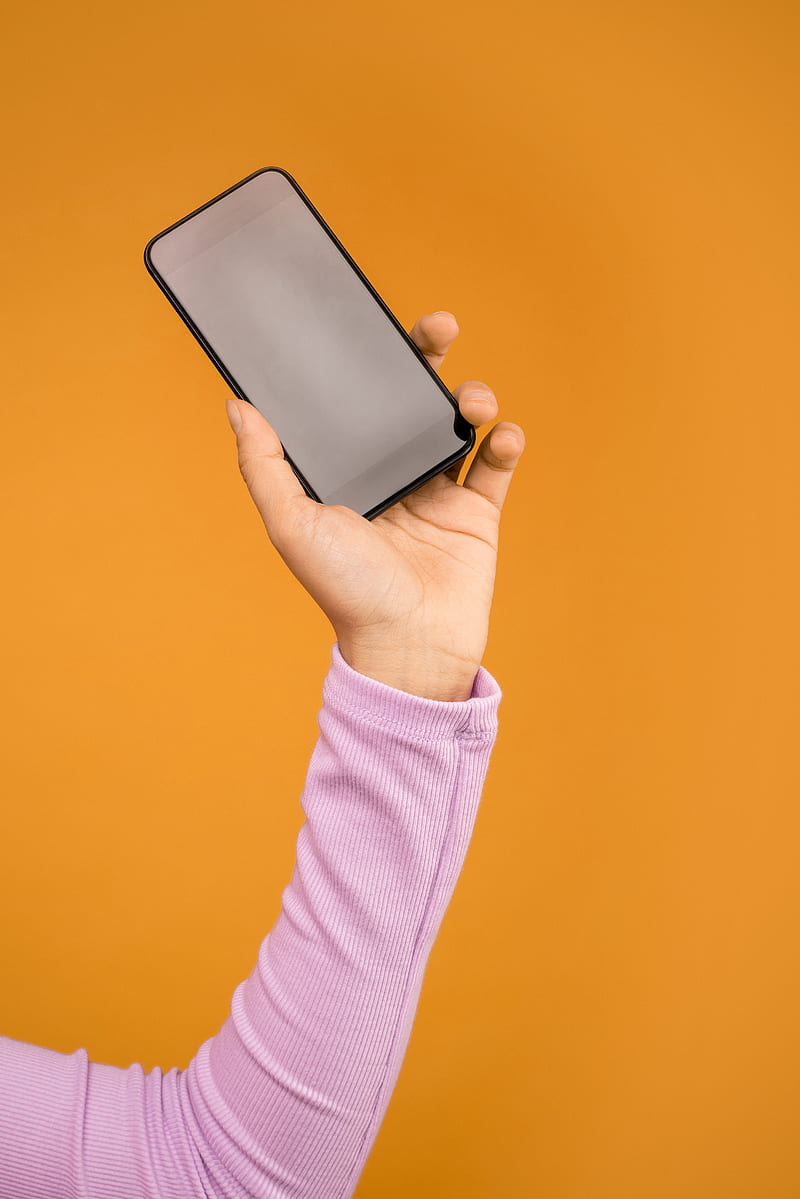 Person Holding Black Smartphone In Orange Background, HD phone ...