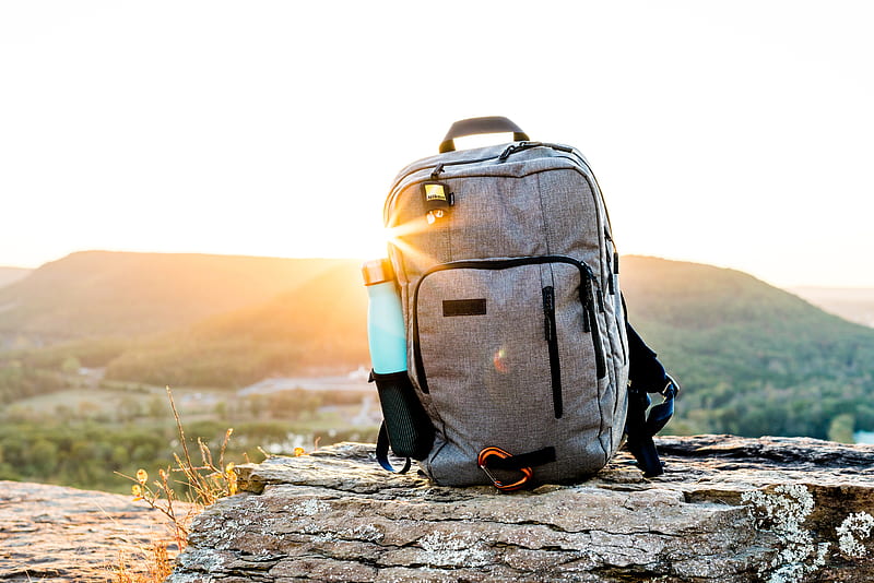 grey and black hiking backpack and cyan tumbler on grey rock during sunset, HD wallpaper