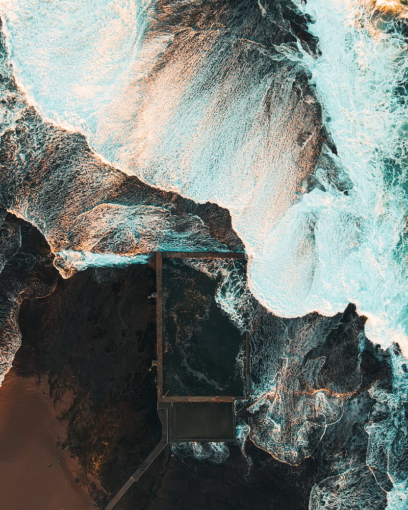 Brown Rock Formation Near Body Of Water During Daytime Hd Phone