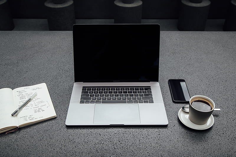 turned-off MacBook Pro between cup of coffee, iPhone, notebook, and pen, HD wallpaper