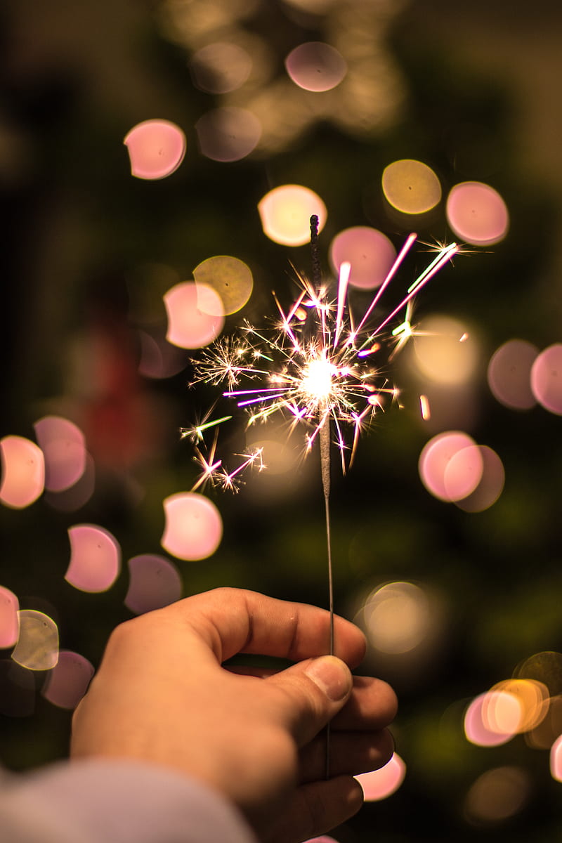 bokeh graphy of person holding fireworks, HD phone wallpaper