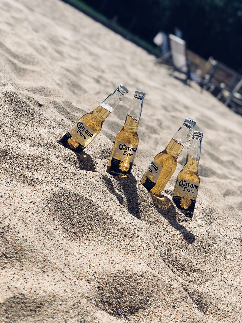 four Corona Extra beer bottles in sand, HD phone wallpaper