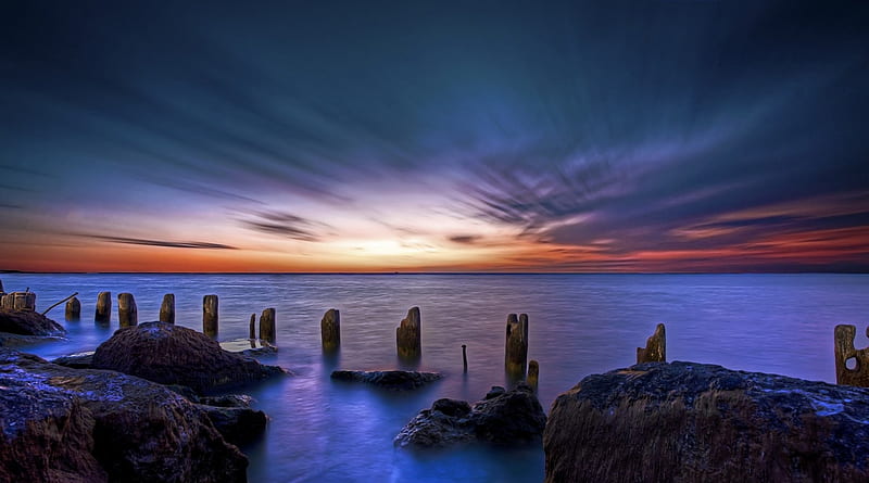 dawn over old pylons at the seashore, rocks, shore, dawn, clouds, pylons, sea, HD wallpaper