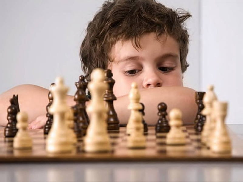 Concentrated serious boy developing chess gambit, strategy ,playing board  game to winner clever concentration and thinking child while playing chess.  Learning, tactics and analysis concept. 7292813 Stock Photo at Vecteezy