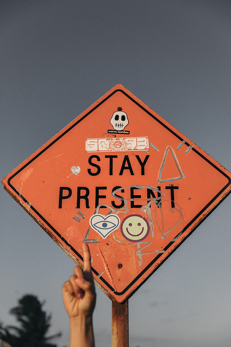 person pointing Stay Present road sign during daytime, HD phone wallpaper