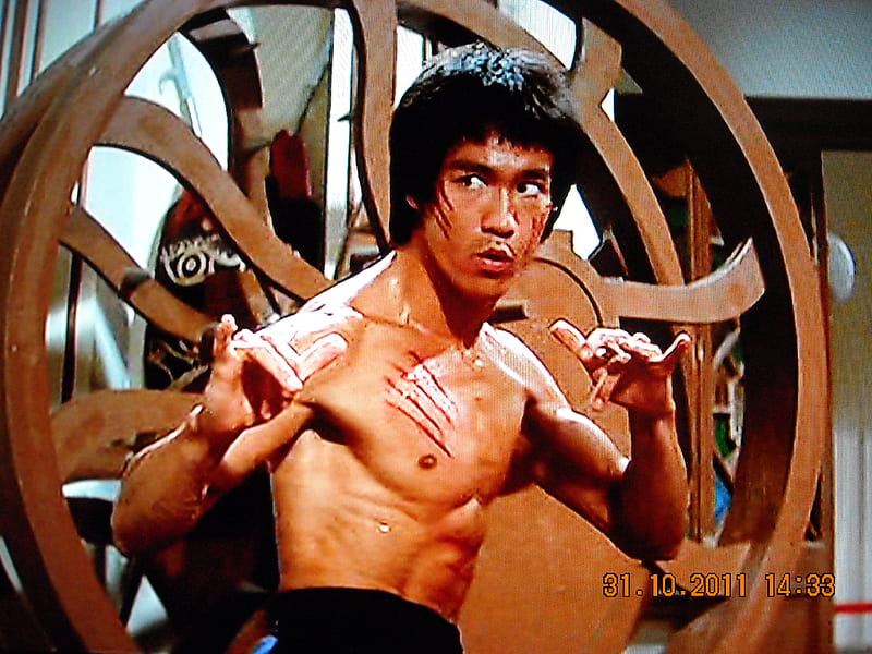Ultra detailed ultimate epic poster of Bruce Lee in a fighting pose with a  dragon symbol behind him