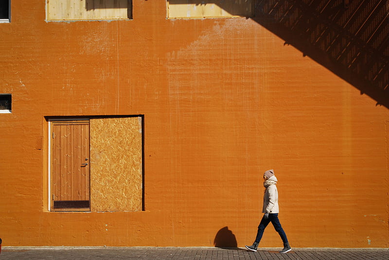 man walking beside orange building at daytime, HD wallpaper