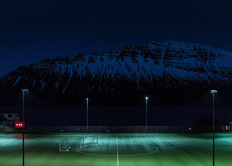 / turf soccer pitch illuminated by floodlights under the snow covered hill at night, training, HD wallpaper