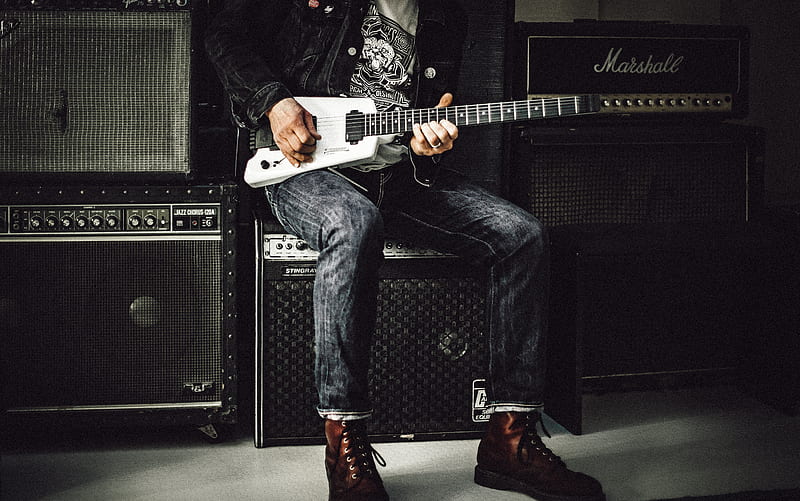 man wearing blue denim jeans playing white and black electric guitar sitting on black guitar amplifier, HD wallpaper