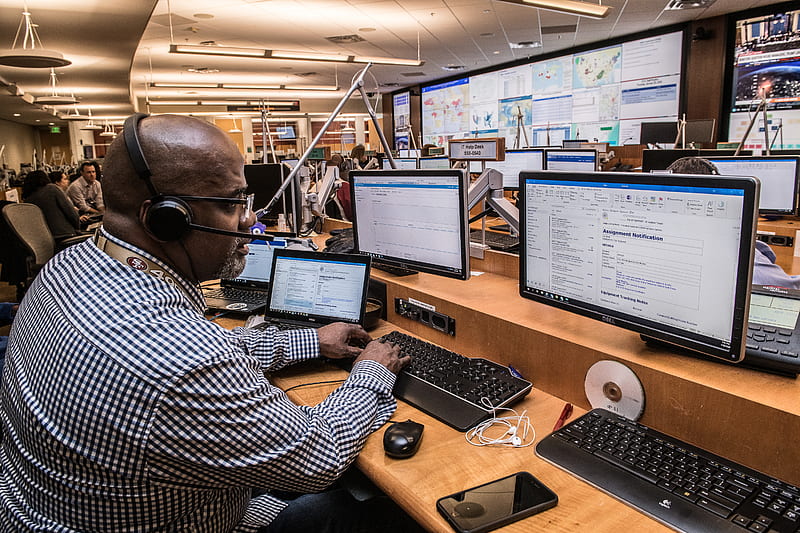 Man in black and white checkered dress shirt using computer, HD