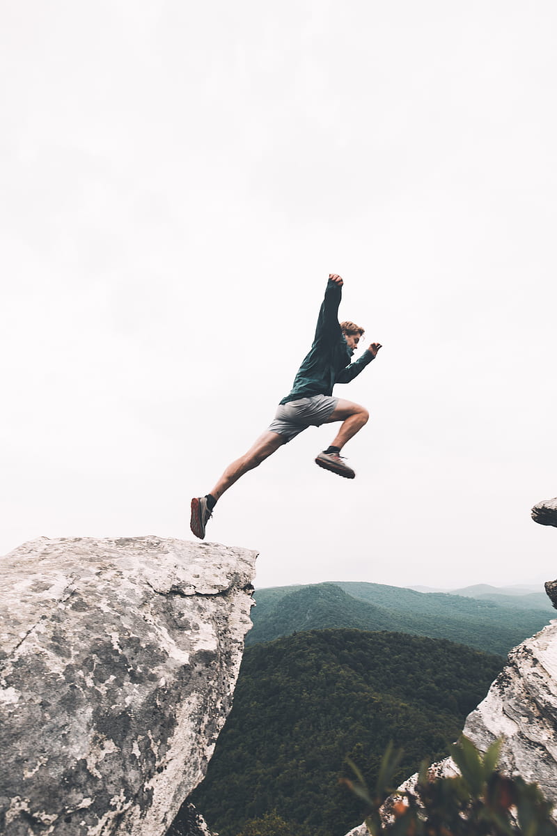 man jumping above rock mountain, HD phone wallpaper