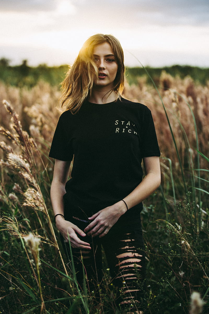 selective focus graphy of black crew-neck t-shirt and distressed black bottom standing on brown wheat field during daytime, HD phone wallpaper