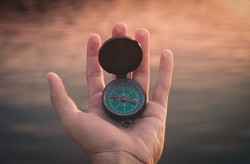 person holding black and green compass pointing to west, HD wallpaper
