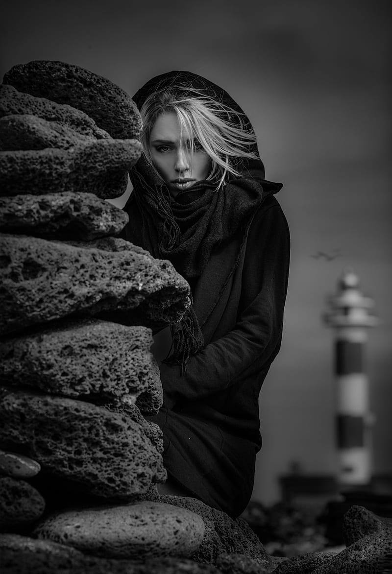 Joachim Bergauer, lighthouse, stones, , women, model, women outdoors, monochrome, black coat, blonde, HD phone wallpaper