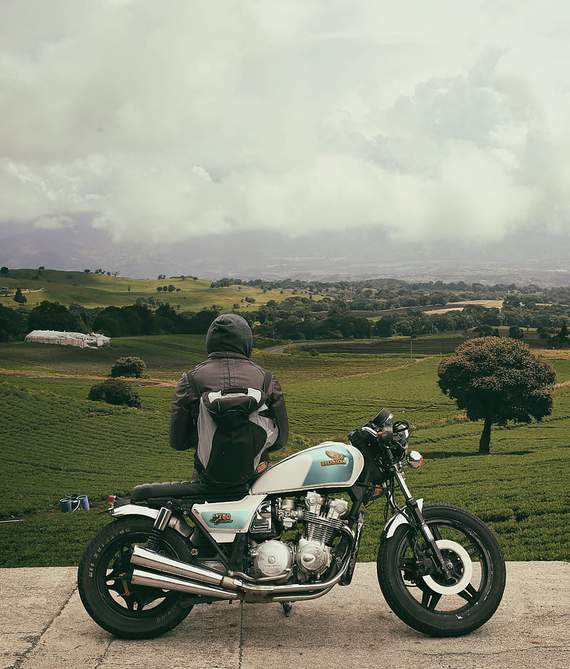 man sitting on motorcycle while facing broad green field, HD phone wallpaper