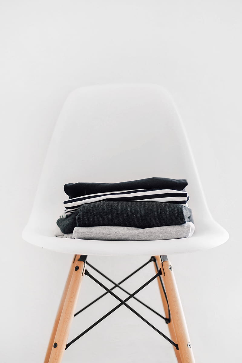 pile of black, white, and gray textiles on white padded chair with brown frame, HD phone wallpaper
