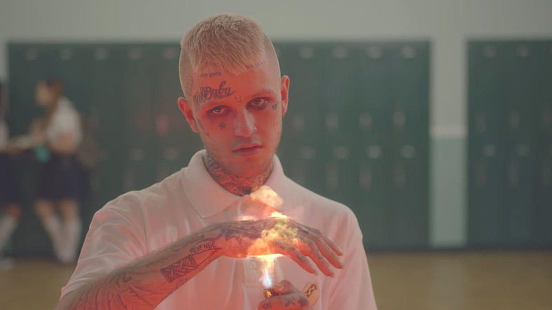 lil peep is putting hand on fire with tattoos on face hand neck wearing white tshirt in blur background music, HD wallpaper