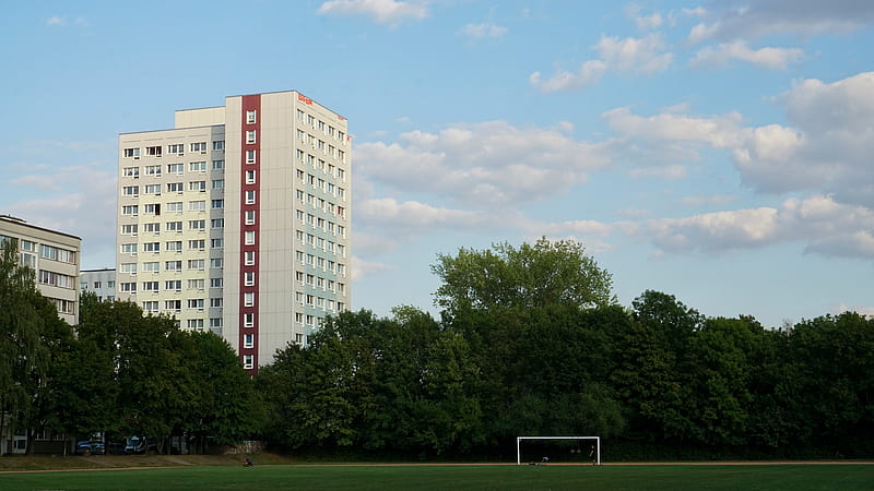 soccer field near white building at daytime, HD wallpaper