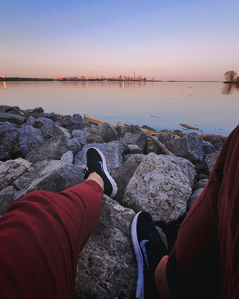 legs, sneakers, rocks, city, horizon, sea, HD phone wallpaper