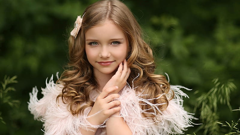 Cute Little Girl Is Standing In Blur Green Leaves Background Wearing ...