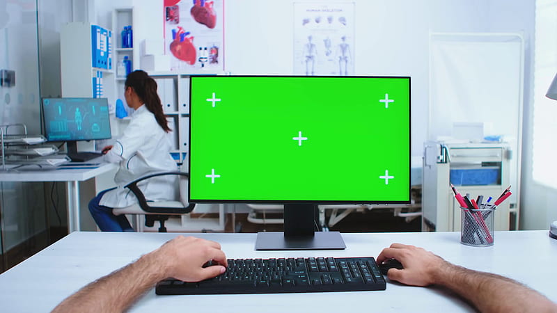 Pov of medical practitioner using computer with copy space available in hospital cabinet and doctor in the background. Medical physician in clinic cabinet working with green screen available. Stock Video Footage, HD wallpaper