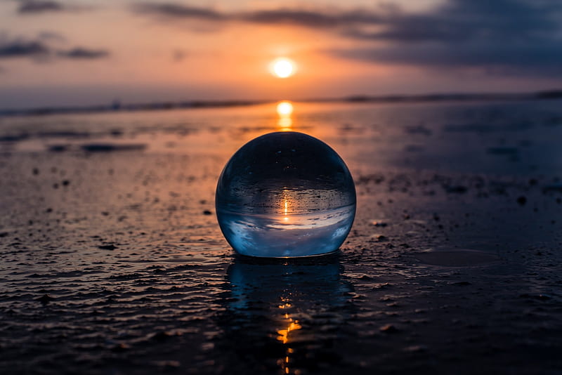 Glass sphere, sand and glass sphere, glass sphere on the beach, glass ...